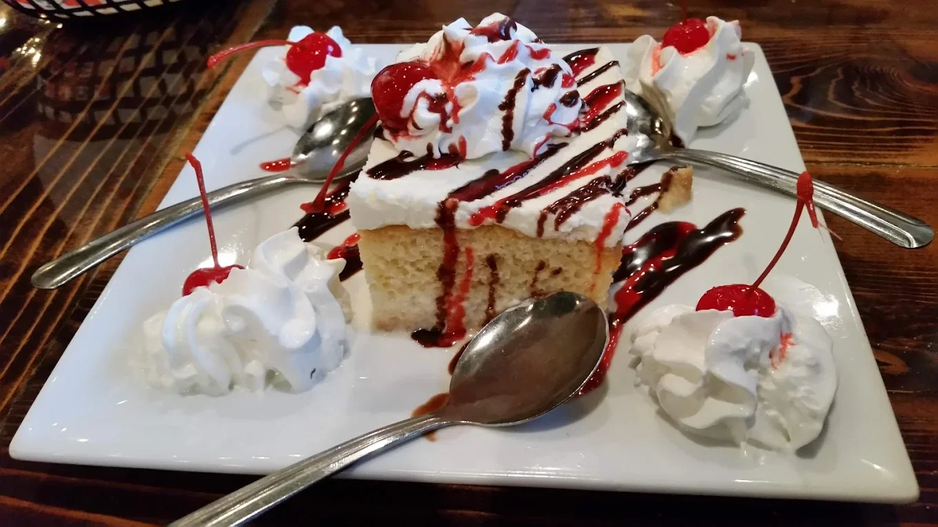 Tres Leches Cake - Moist sponge cake soaked in three milks, topped with whipped cream