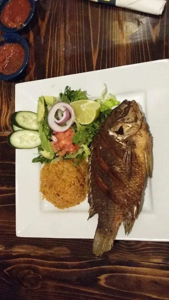 Whole Fried Fish (Mojarra) - Whole mojarra fish fried golden and crispy, served with rice and salad